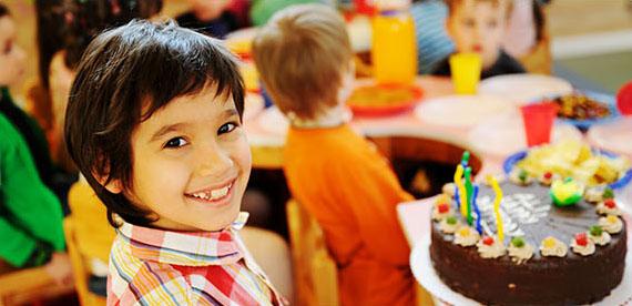 Boy smiling with birthday cake.